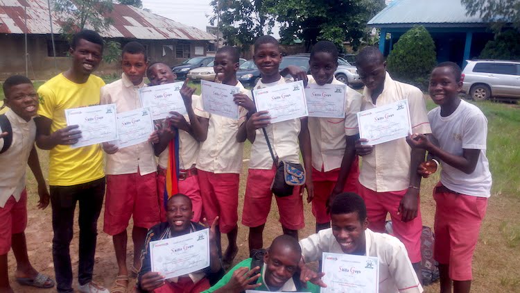 Graduates of the SKILLZ Guyz program and their Coach are all smiles in Lagos, Nigeria